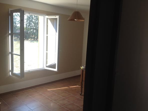 Sunlit room with tiled floor and freshly painted walls
