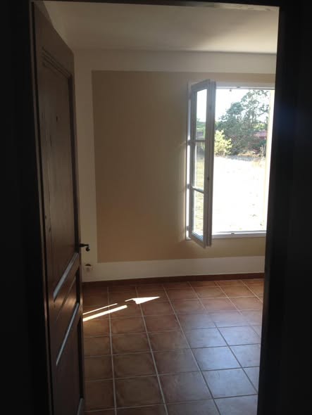 Finished room viewed through doorway, tile floor and two-tone walls