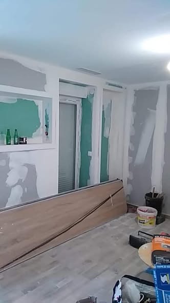 Room renovation with new flooring and plastered drywall